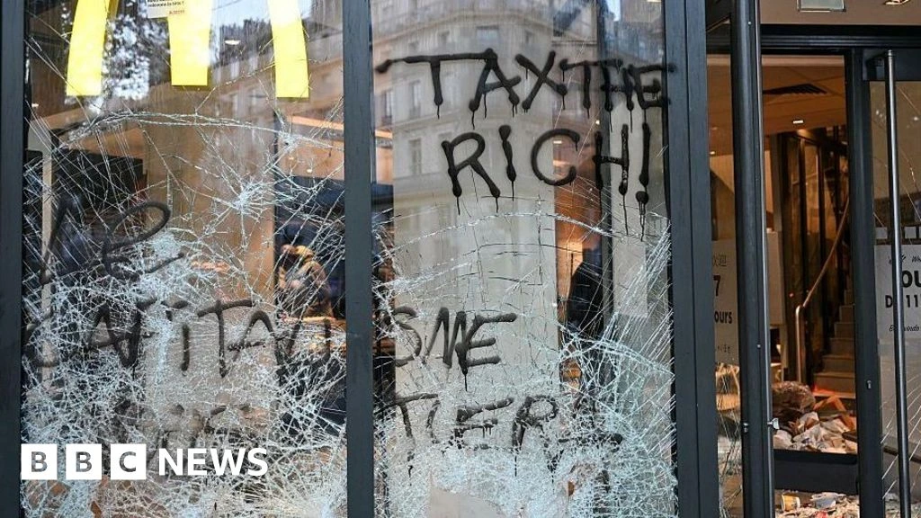 Burnt out cars and shattered glass on Paris streets after protests turn to riots and looting